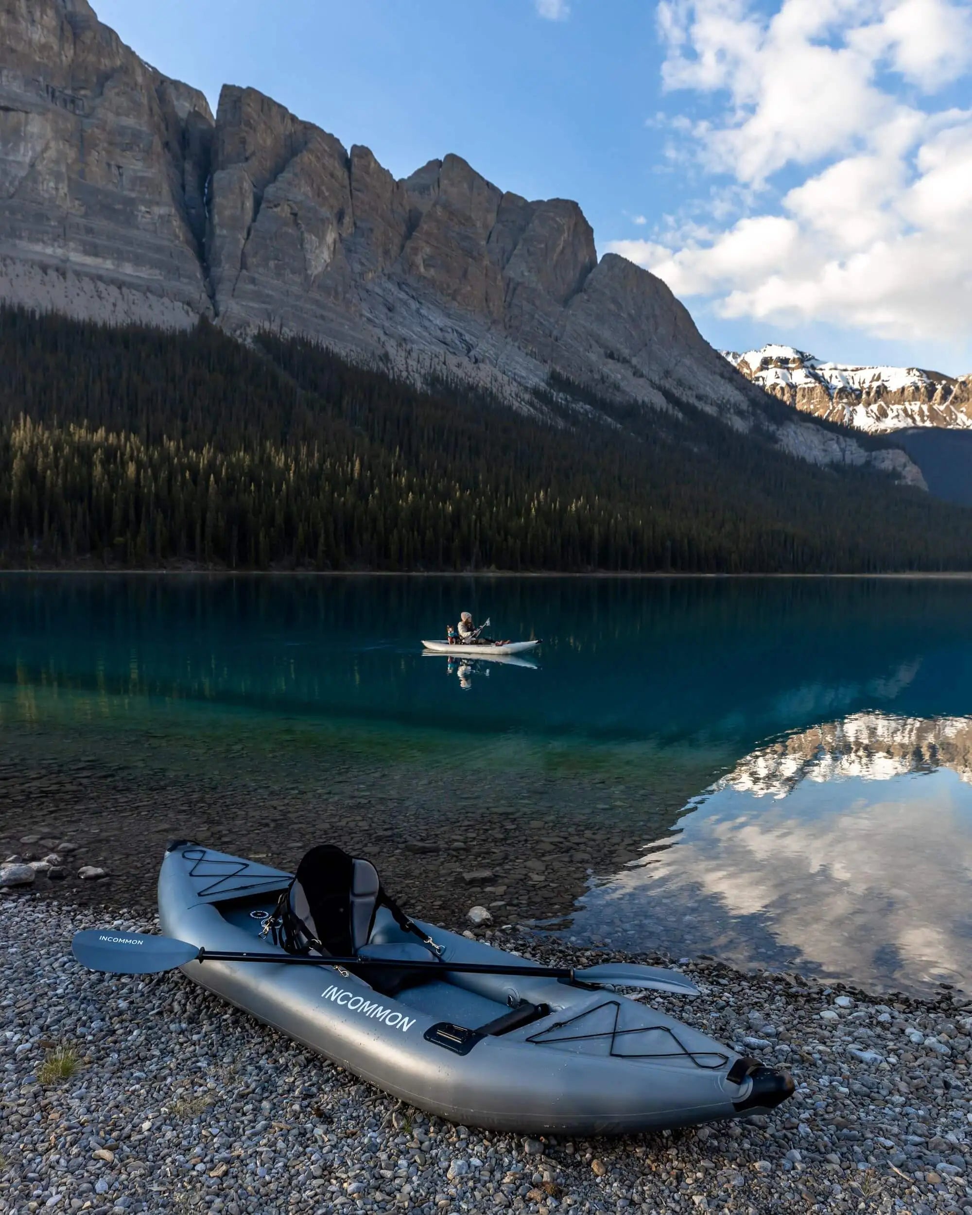 Load video: Video of two women taking the kayaks out on an alpine lake with their dog